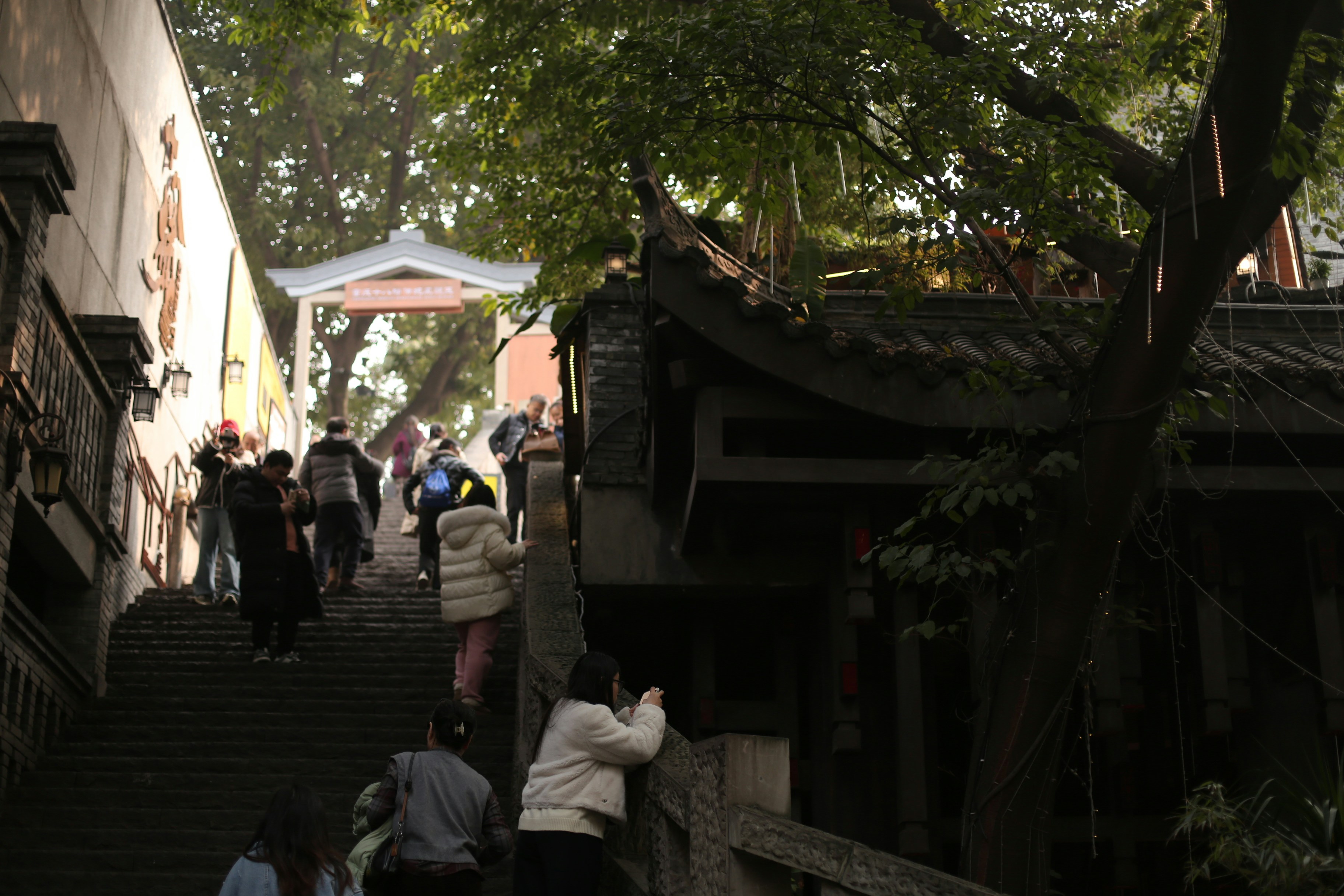 People climbing stairs towards a temple entrance