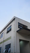 Modern industrial building with large windows and clear sky