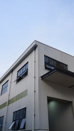 A large modern industrial building under a clear desert sky, similar to the newer distribution warehouses going up in Apex Industrial Park