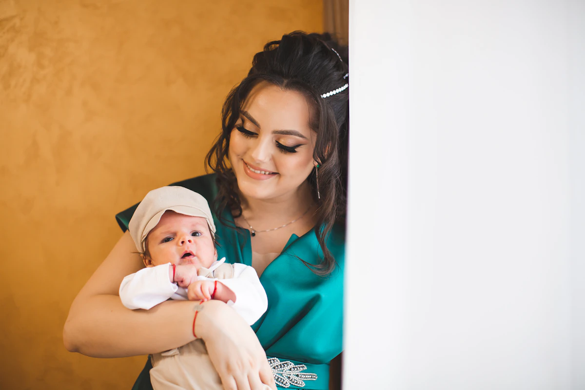 Mother tenderly holding and caring for her newborn baby