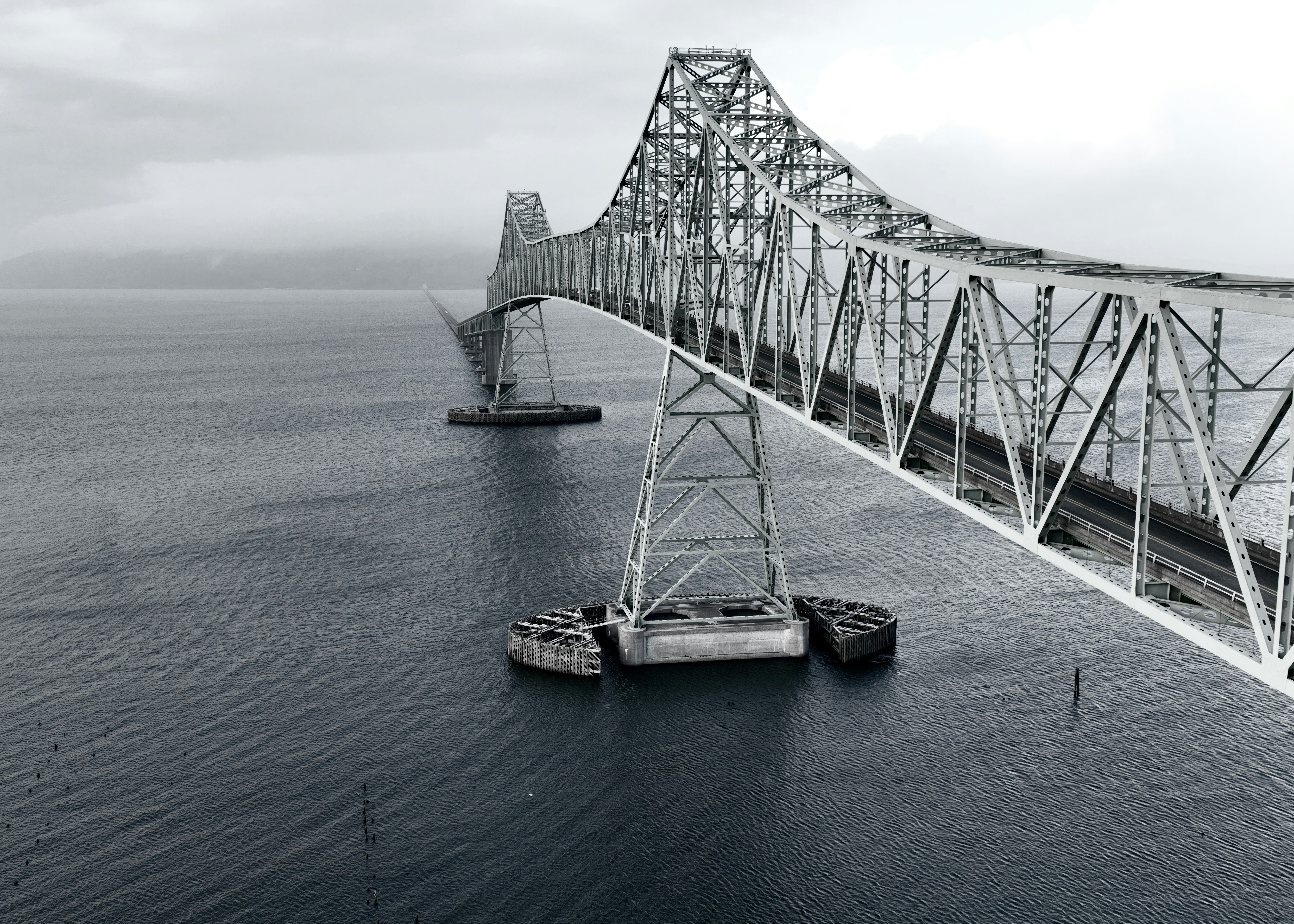 A large metal bridge spans over the water.