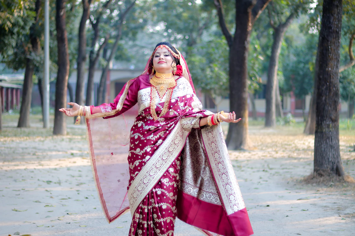 Model in a red and gold bridal saree with traditional jewellery