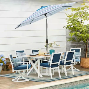 Outdoor dining set with chairs and umbrella by pool