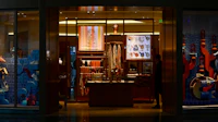 A luxury store window glowing at night