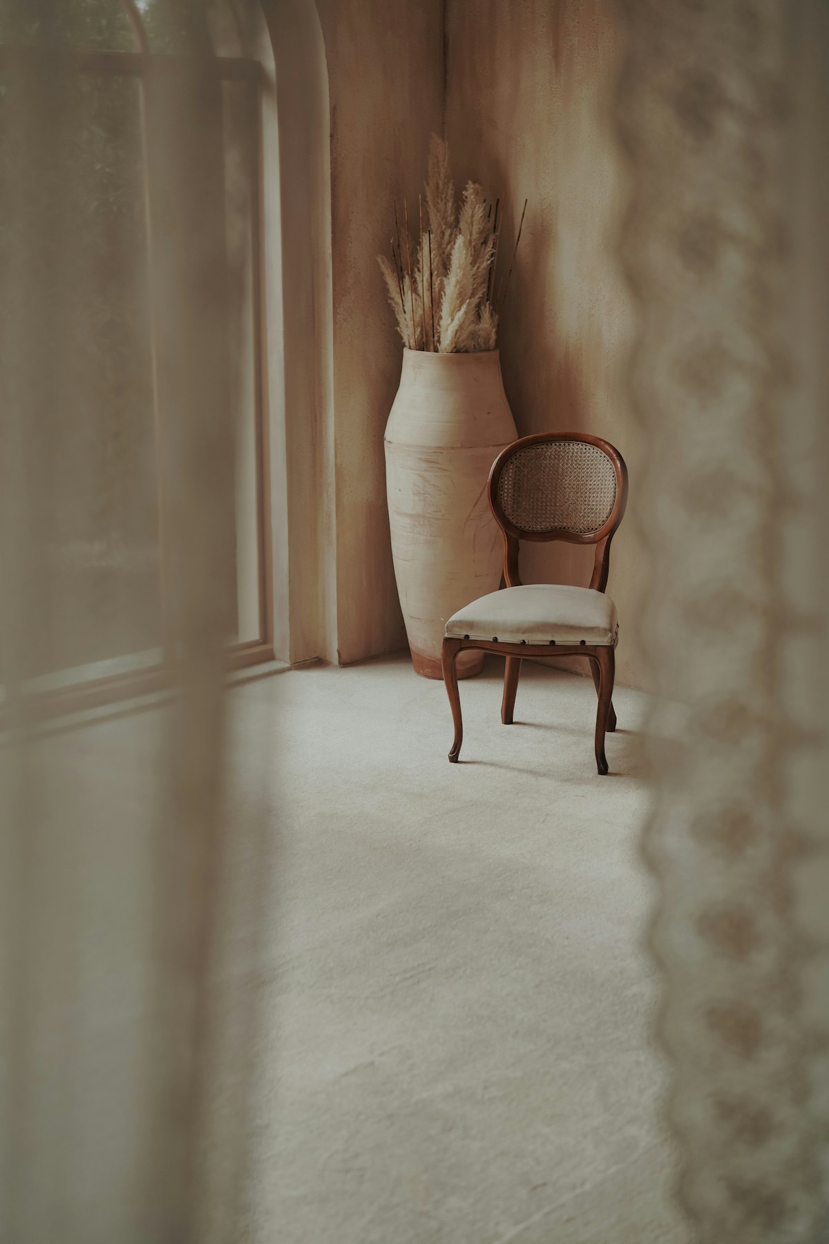 A leather chair by the window — the world of a man of considered taste