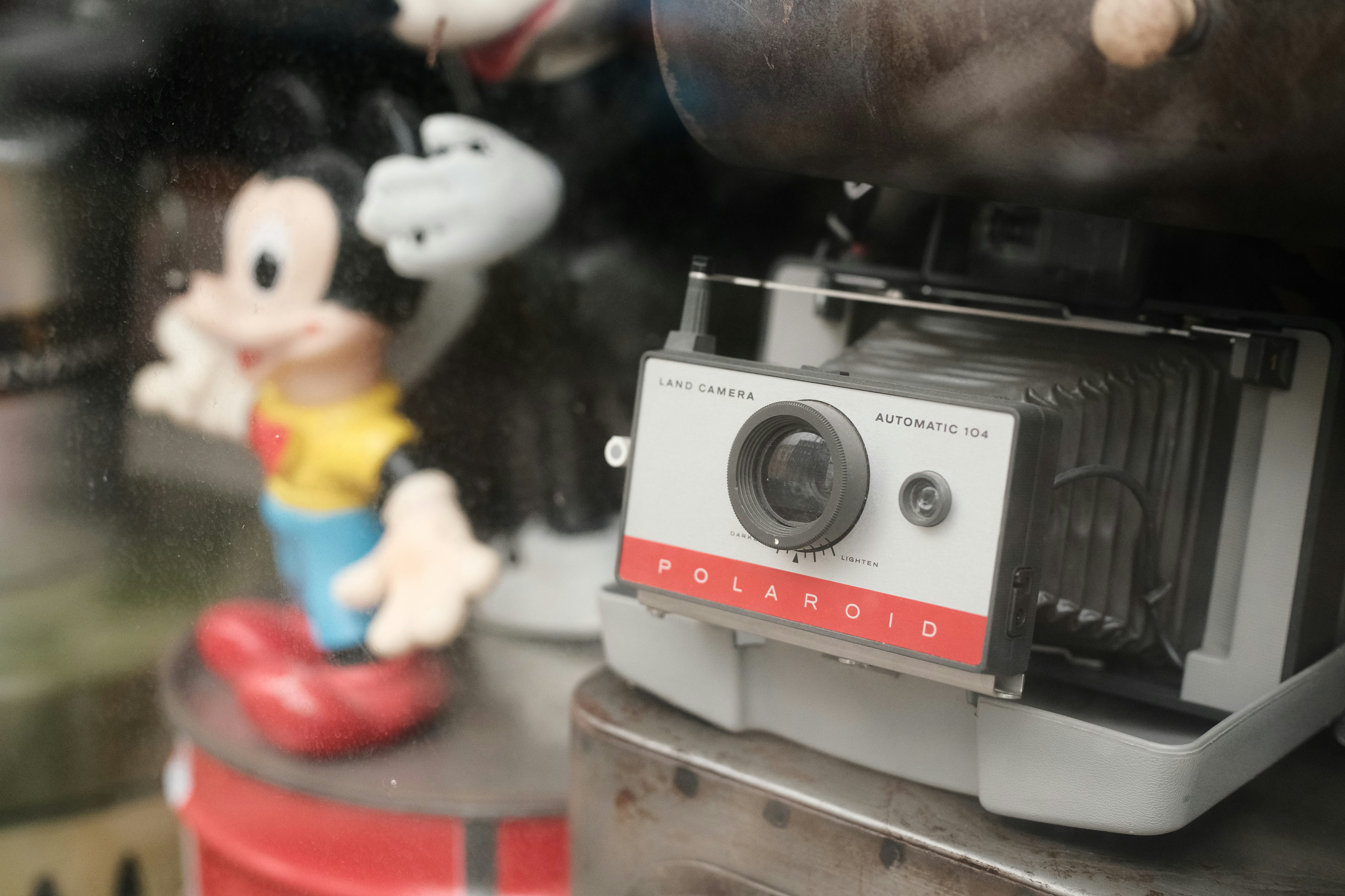 Vintage polaroid camera with mickey mouse figures
