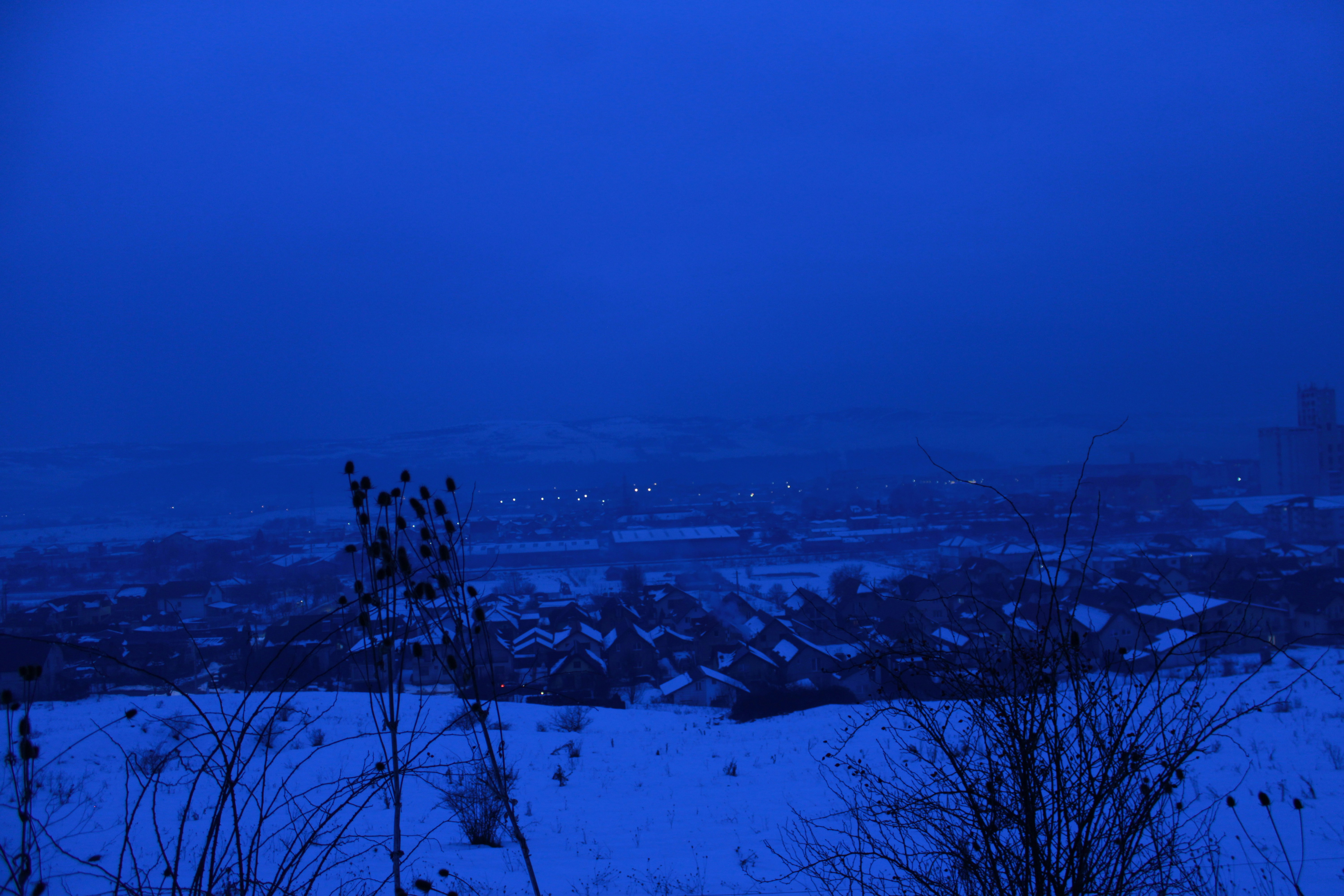 A snowy landscape under a deep blue sky.