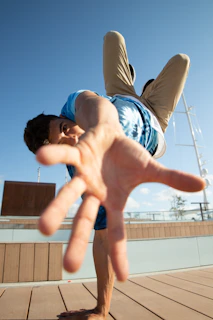 Man in mid-air, reaching out towards camera