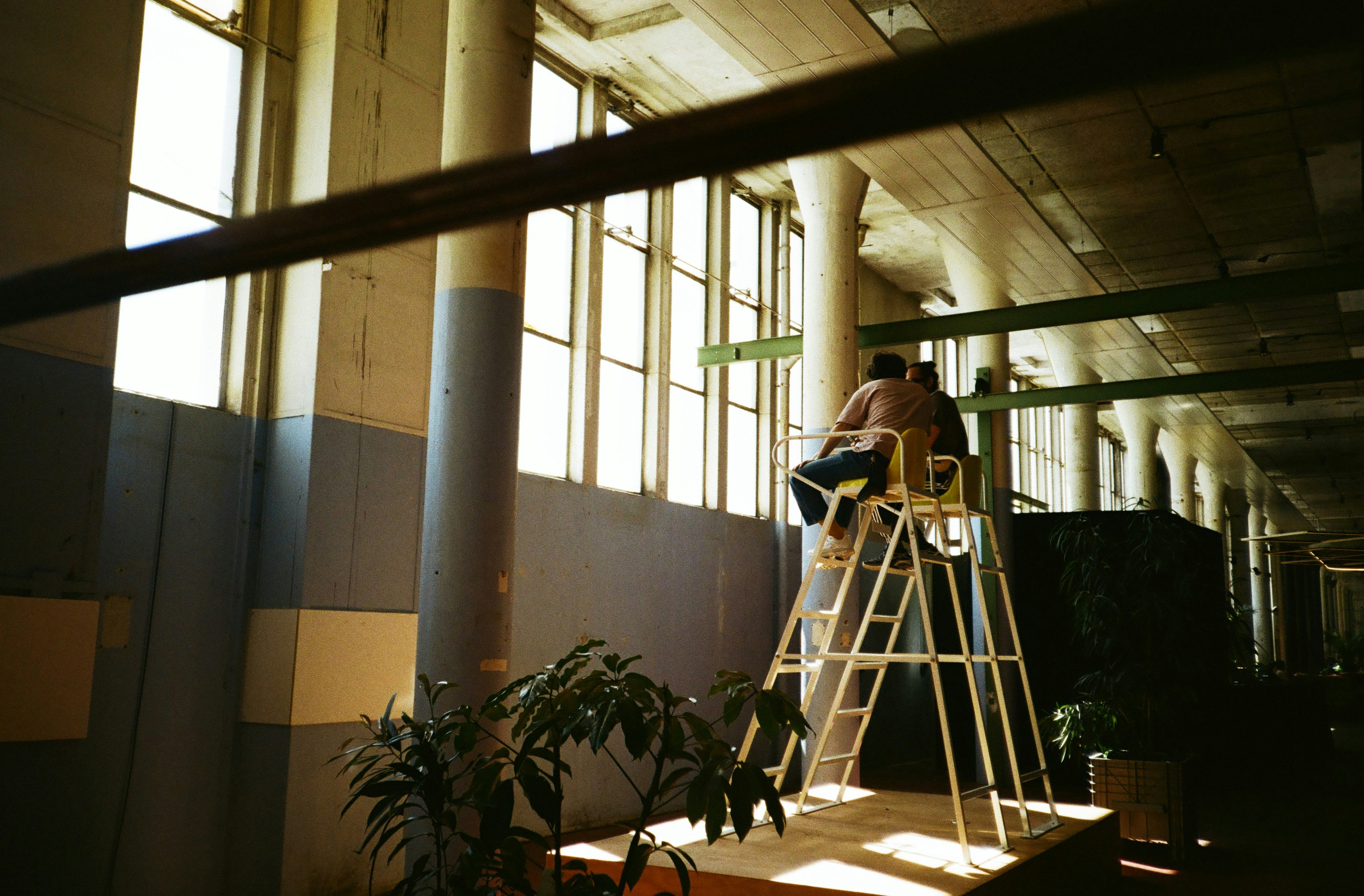 Due persone su una scala vicino a grandi finestre