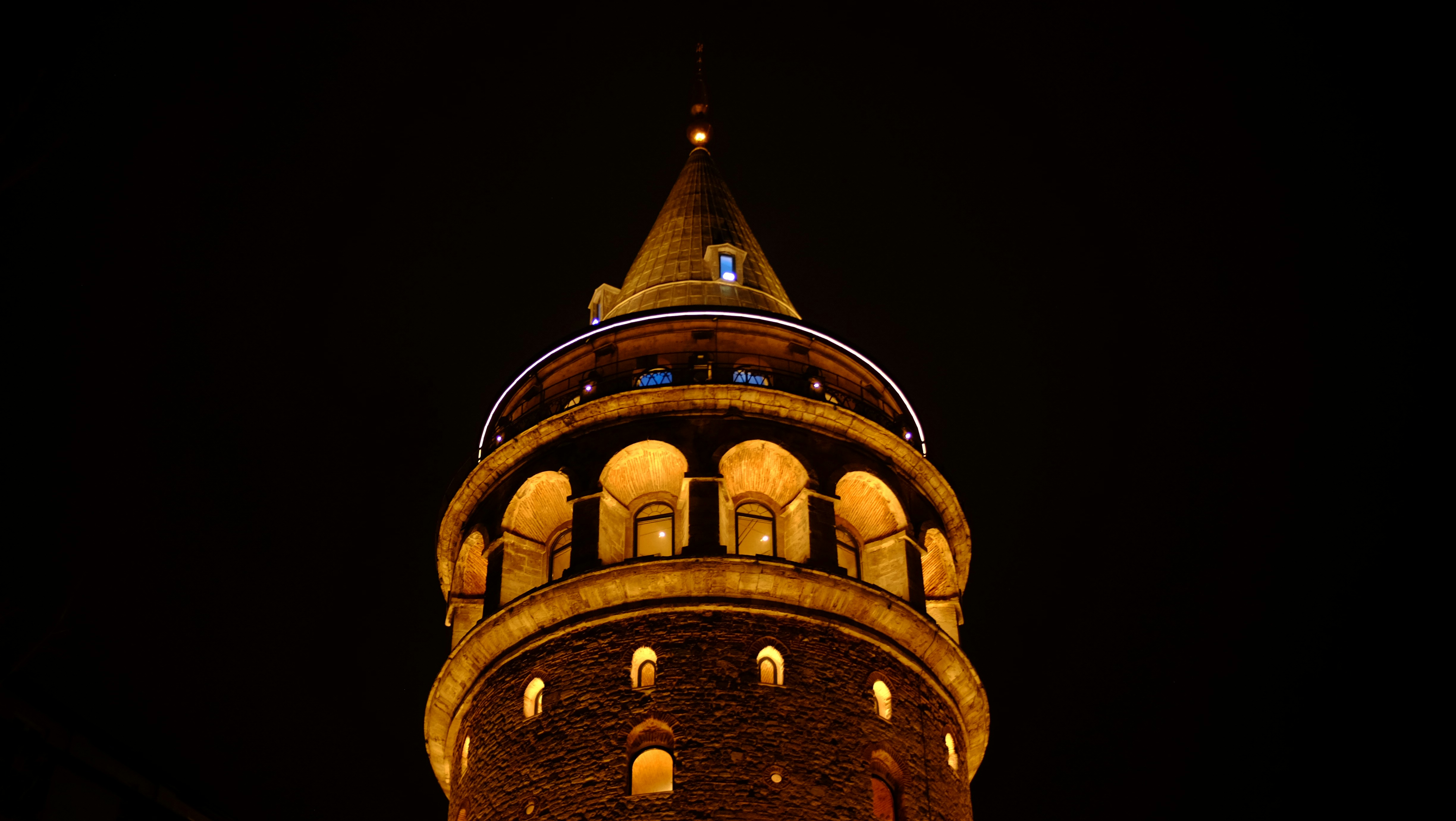 Galata tower illuminated at night against dark sky