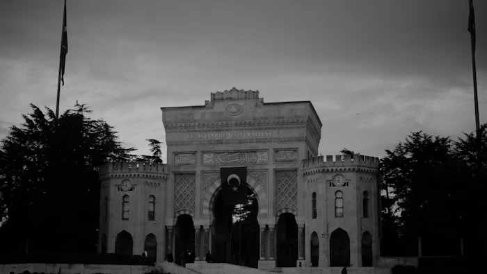 Grand university building with a statue in front