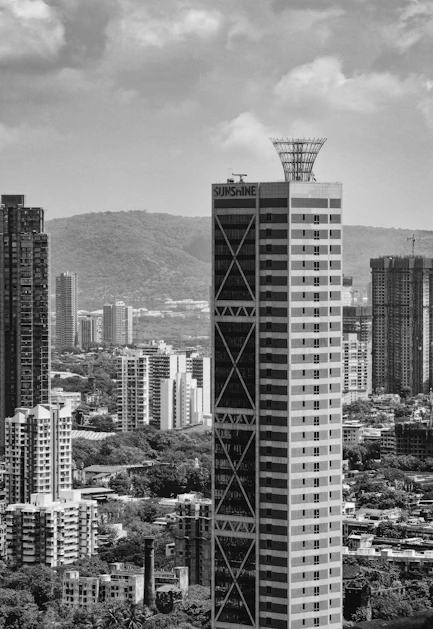 Tall modern skyscrapers rise above a city skyline.
