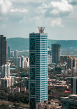 Modern skyscraper with blue glass facade in cityscape.