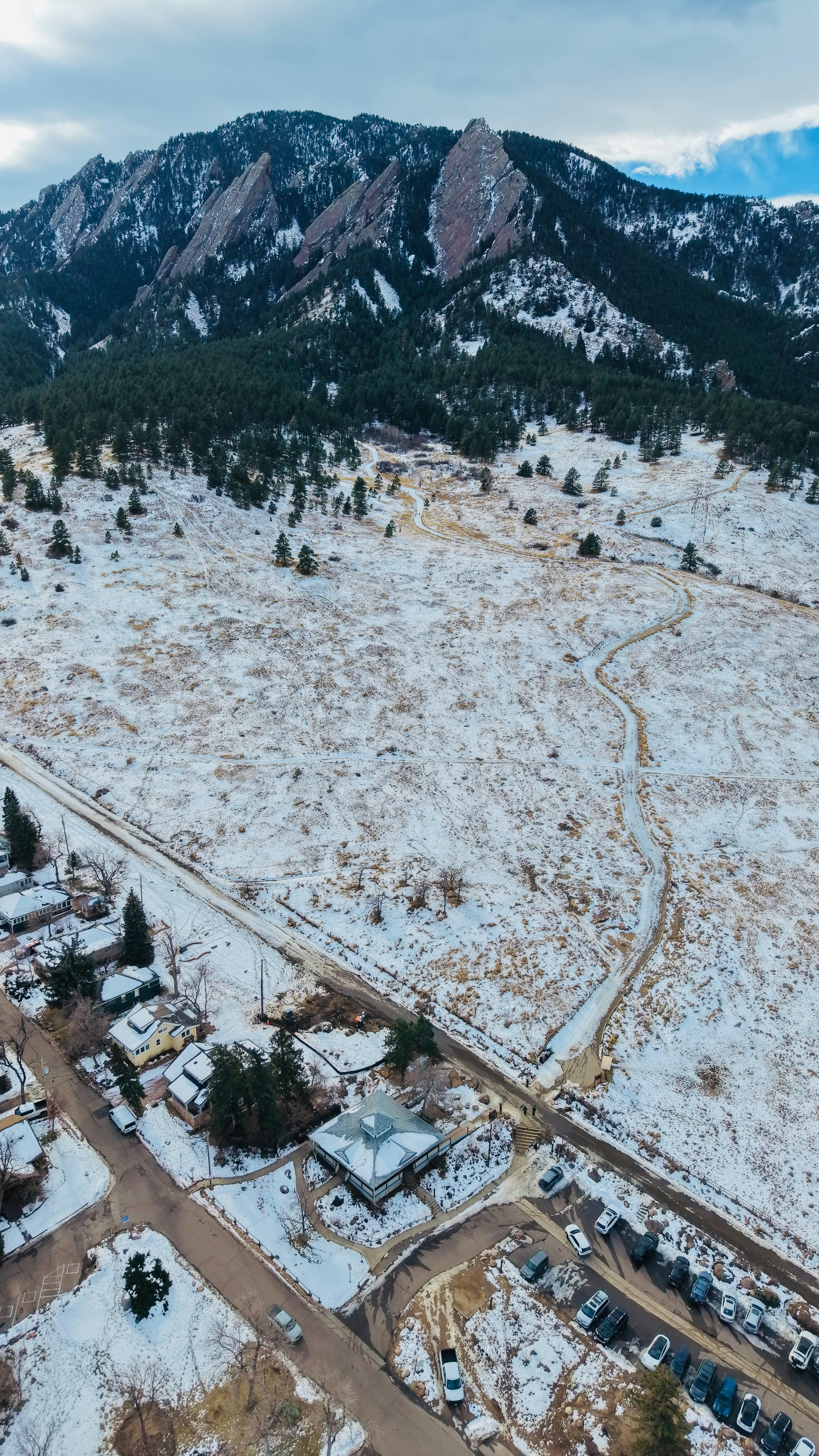 Snow-covered landscape with mountains and a small town.