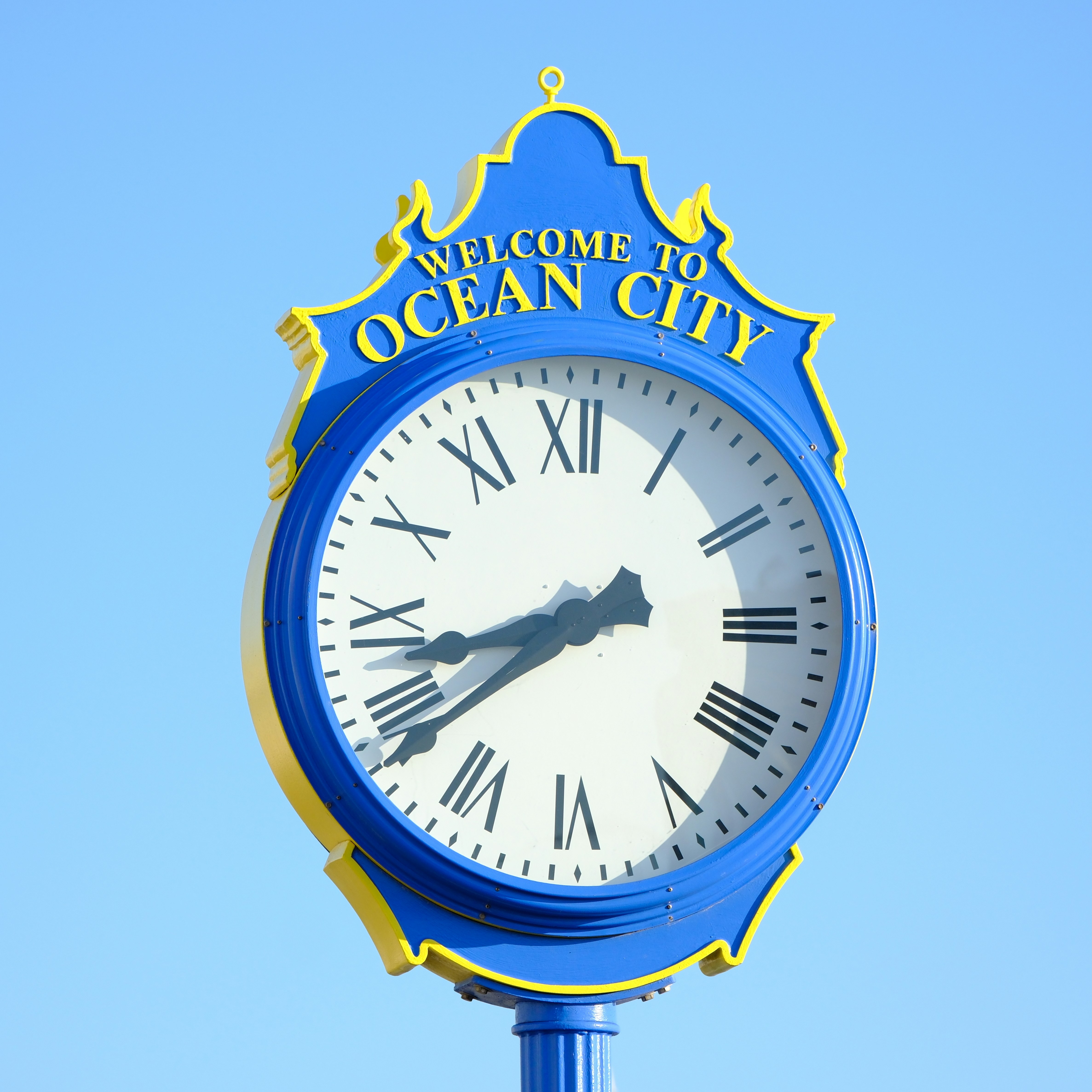 Welcome to ocean city clock against blue sky