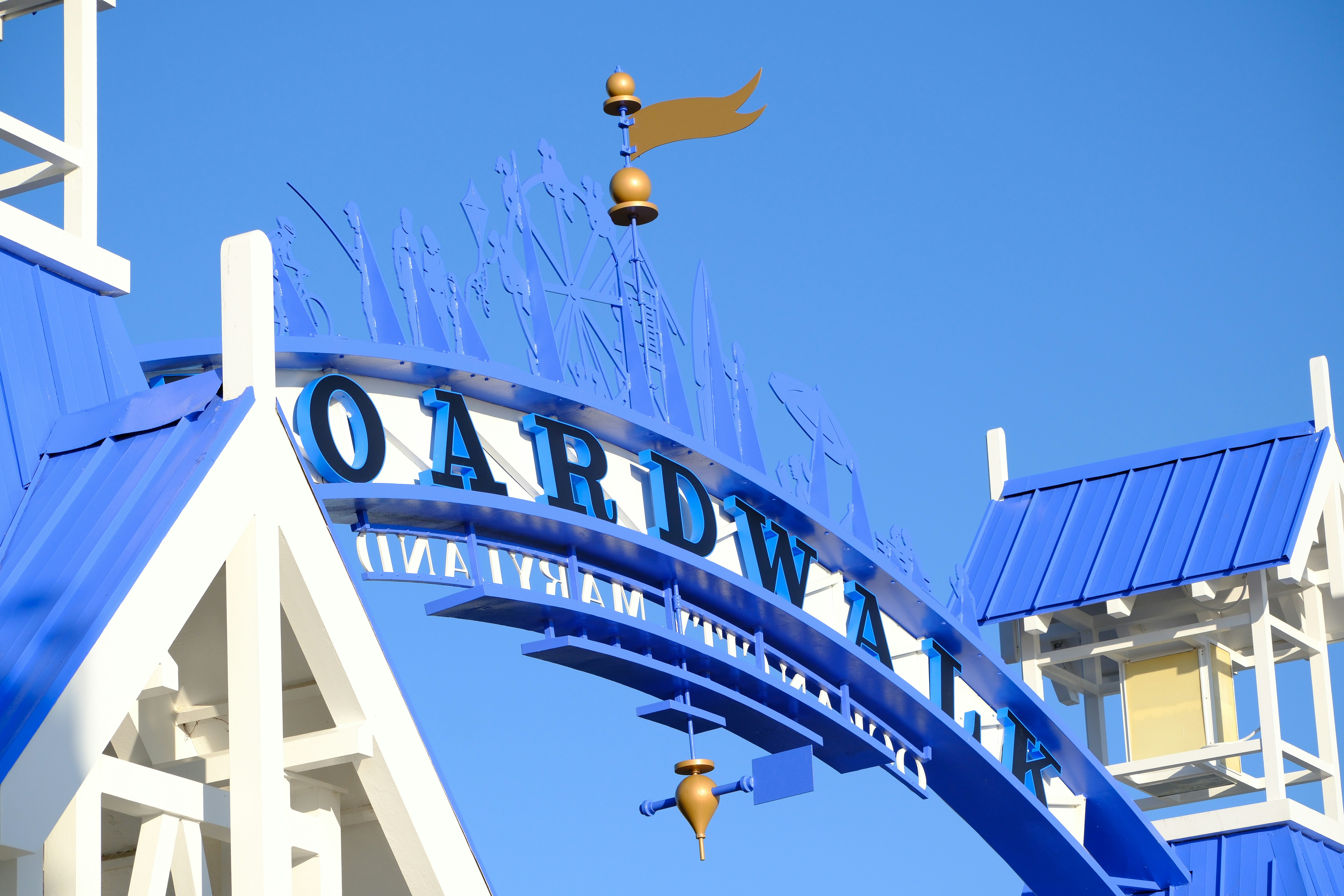 Blauer Torbogen mit Boardwalk-Schild unter klarem Himmel
