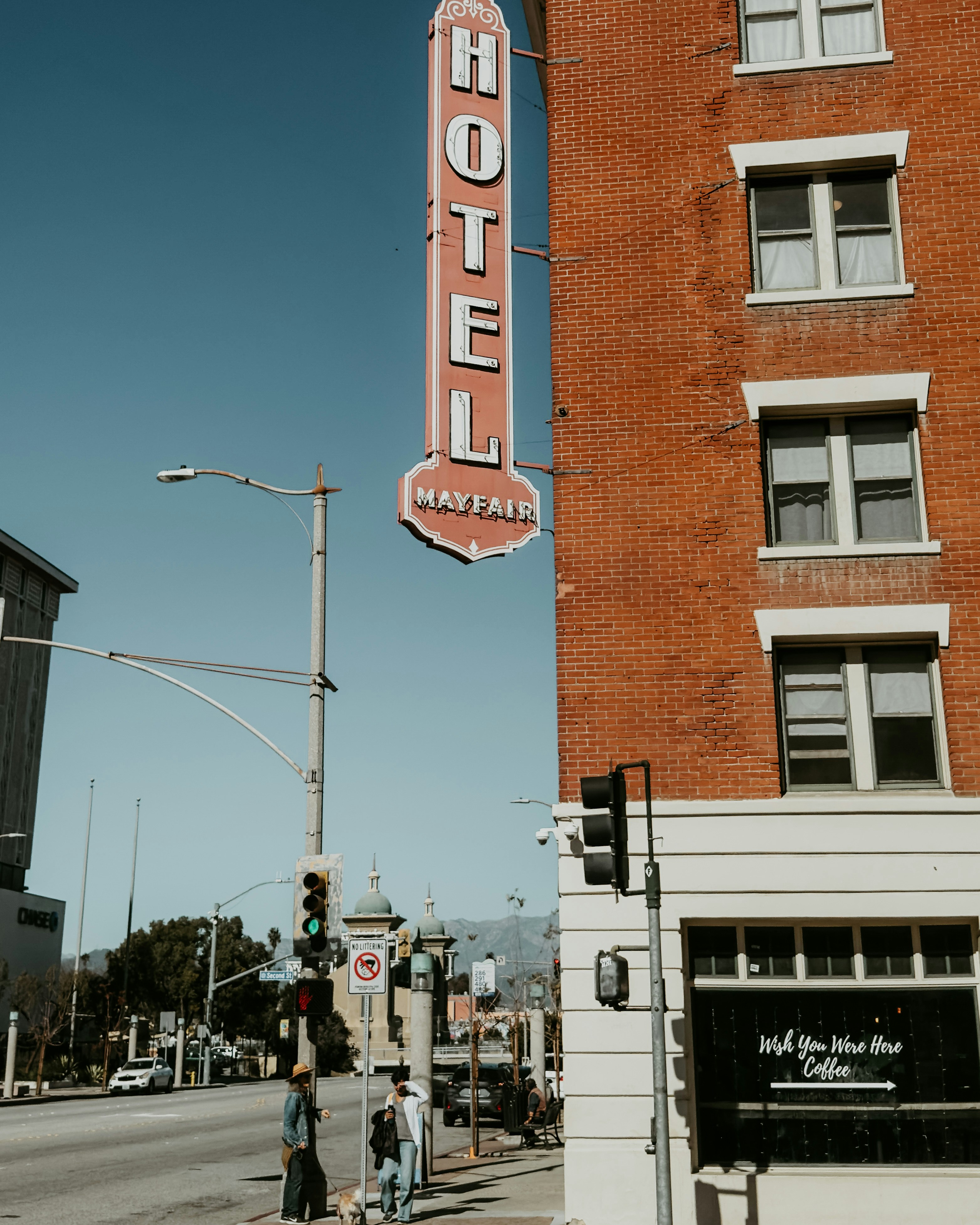 A vintage hotel sign on a brick building.