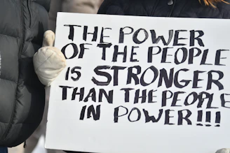 A sign reading the power of the people is stronger
