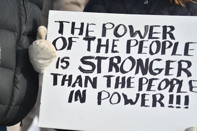 A sign reading the power of the people is stronger