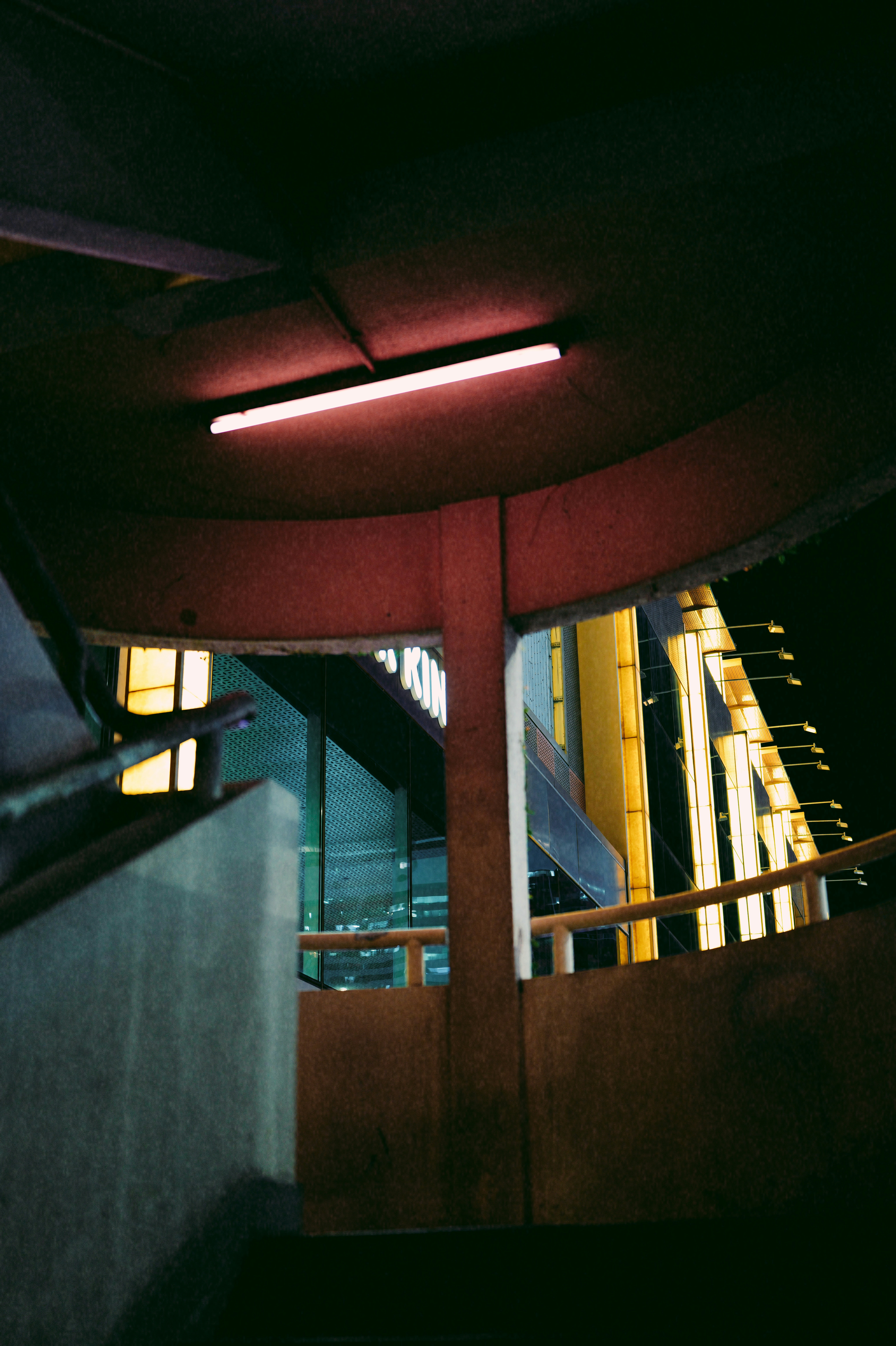 Urban walkway with glowing lights at night.