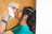 Mother holds her newborn baby near her face.