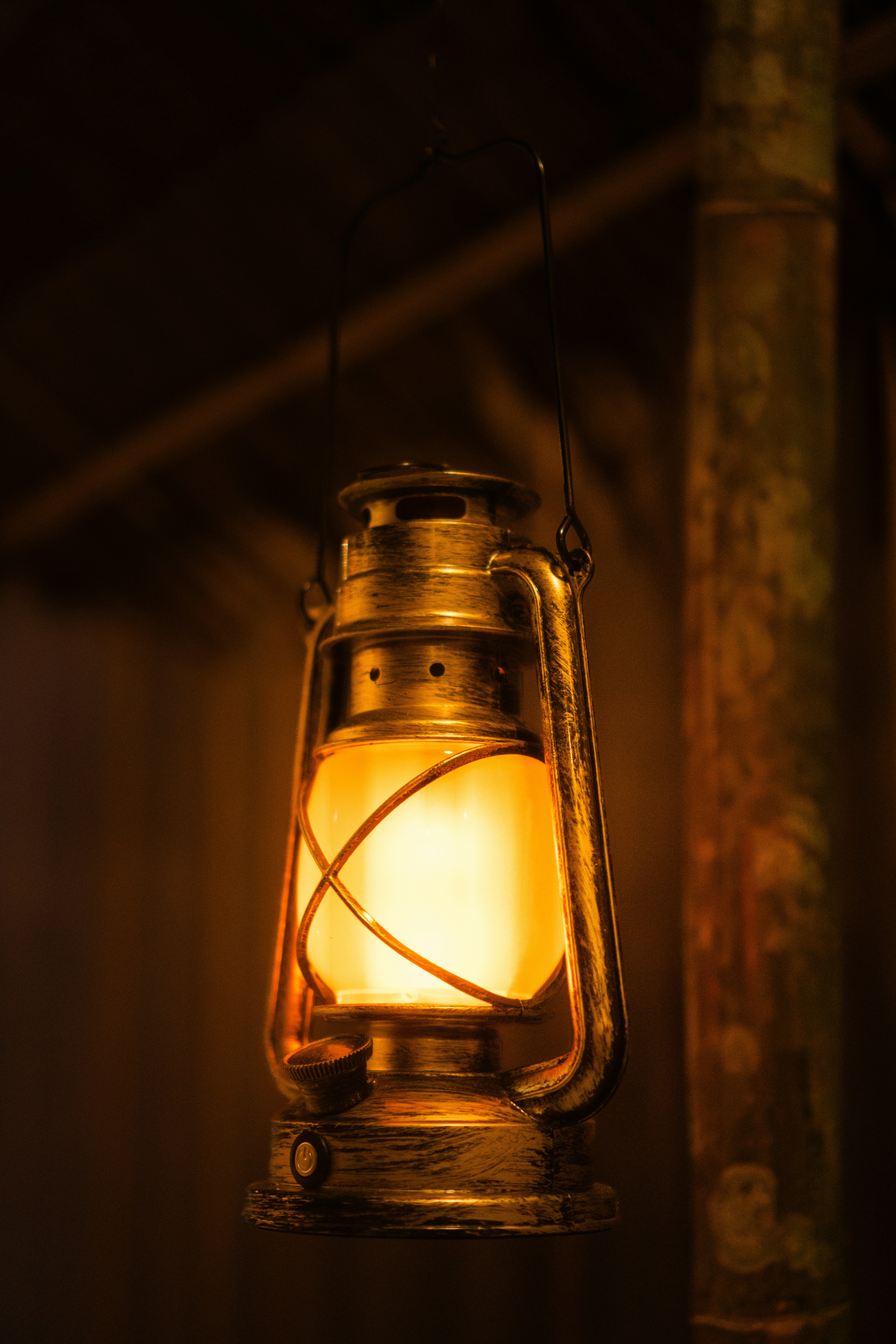 An old lantern glows warmly in the darkness.