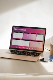 Laptop displaying a colorful february 2026 calendar.