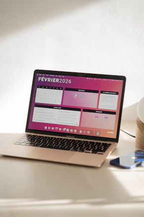 Laptop displaying a colorful february 2026 calendar.