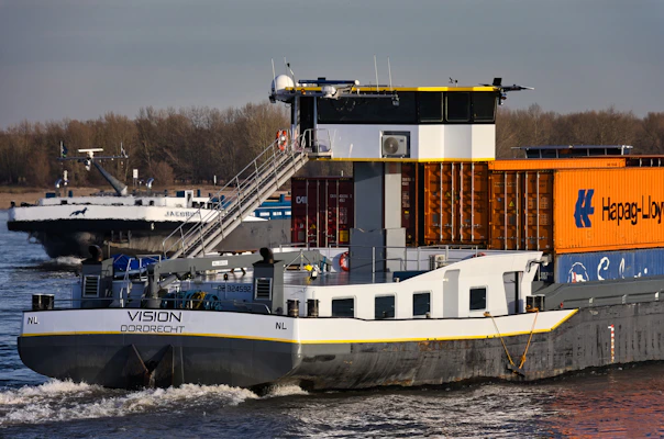 Two cargo ships sailing on a river