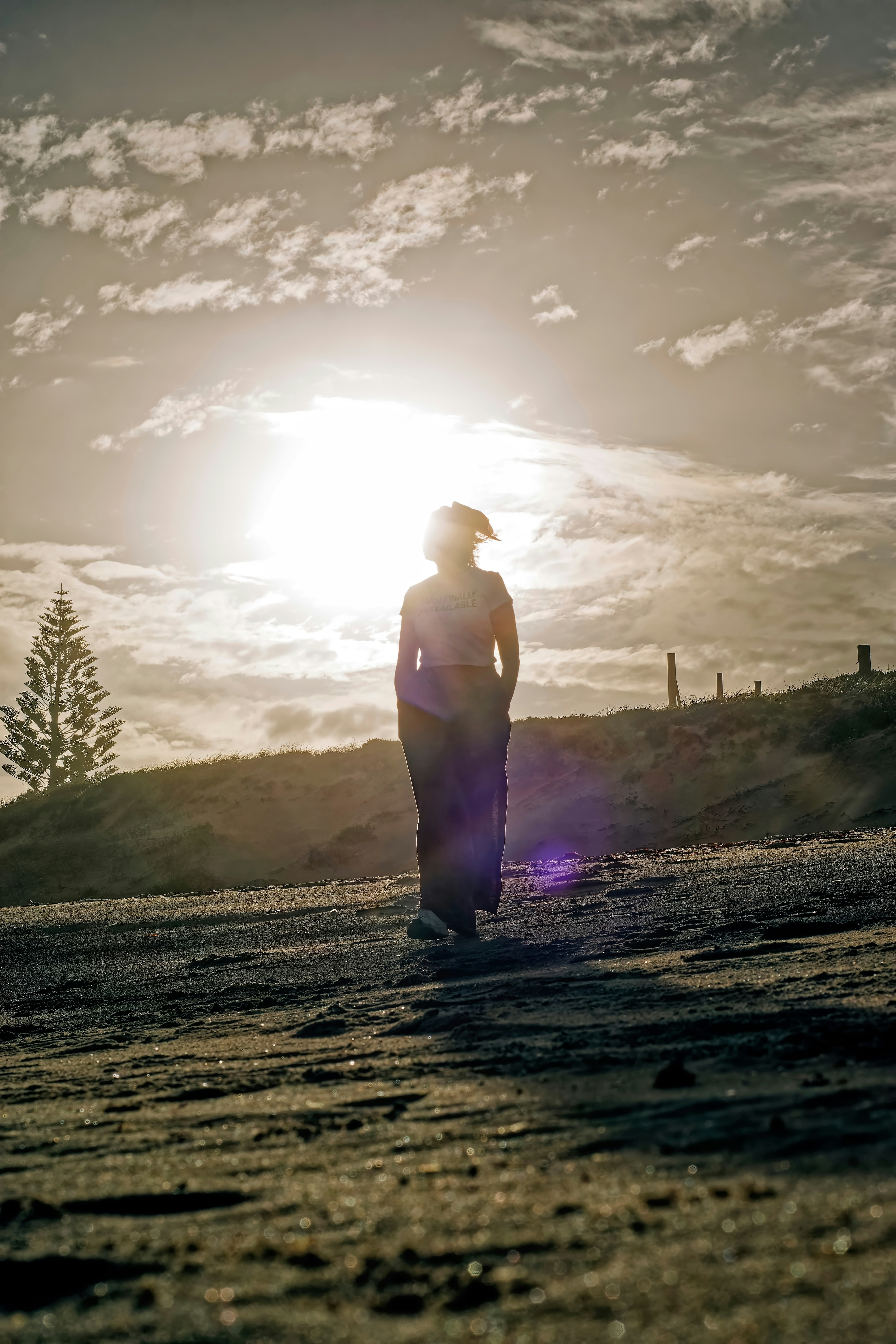 Donna che cammina su una spiaggia al tramonto