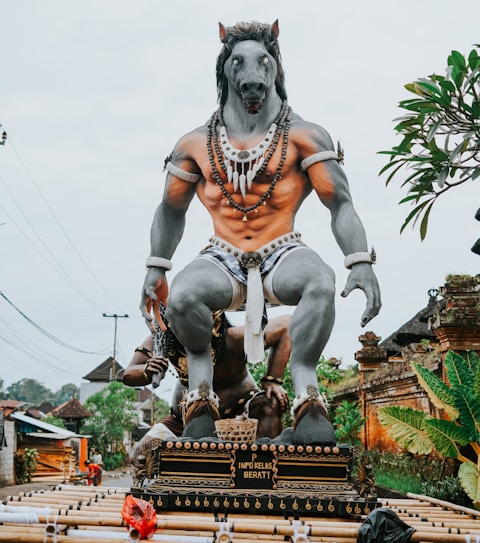Giant mythical creature statue with human-like torso and horse head.