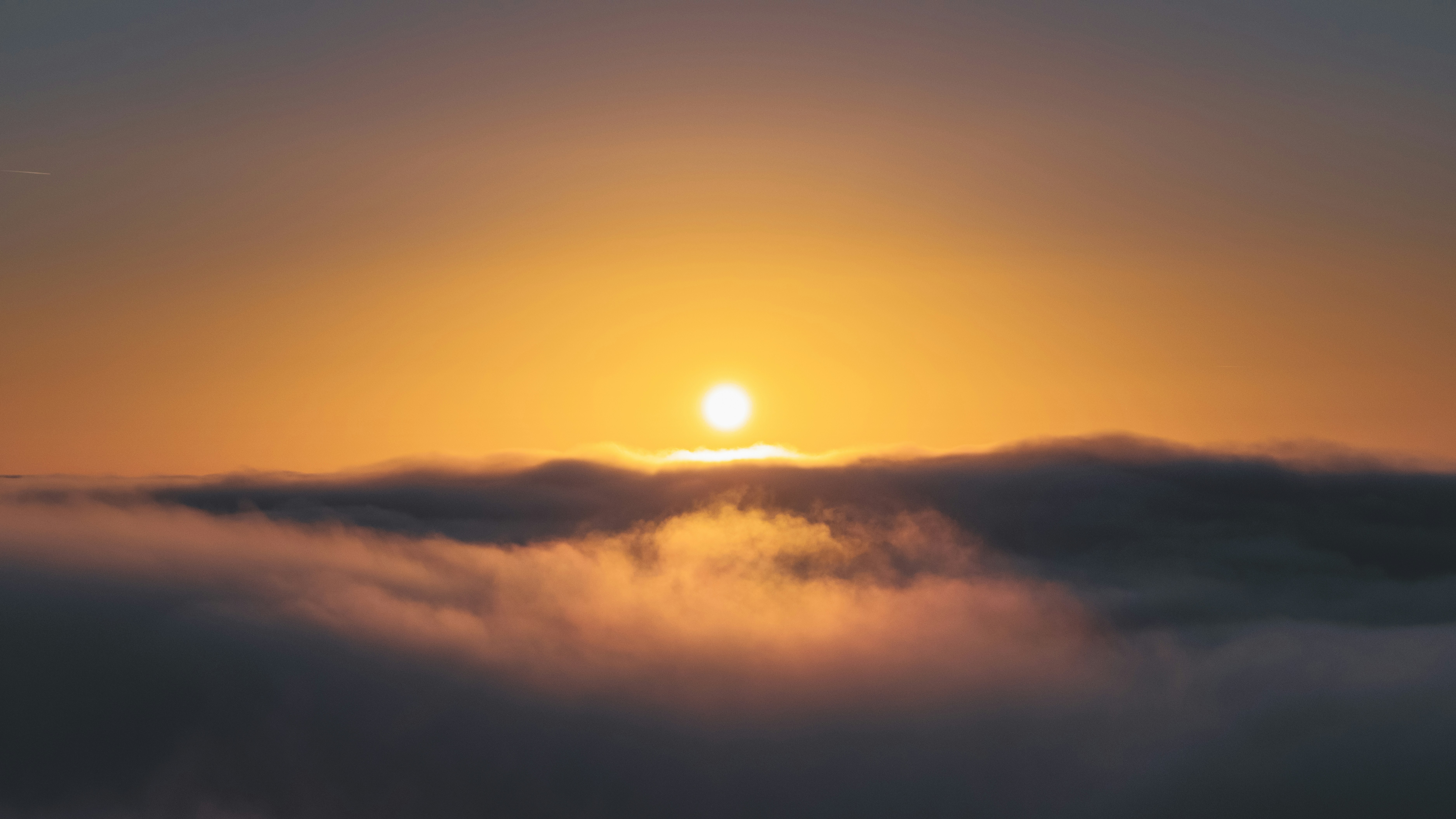 Sun rising over a sea of clouds