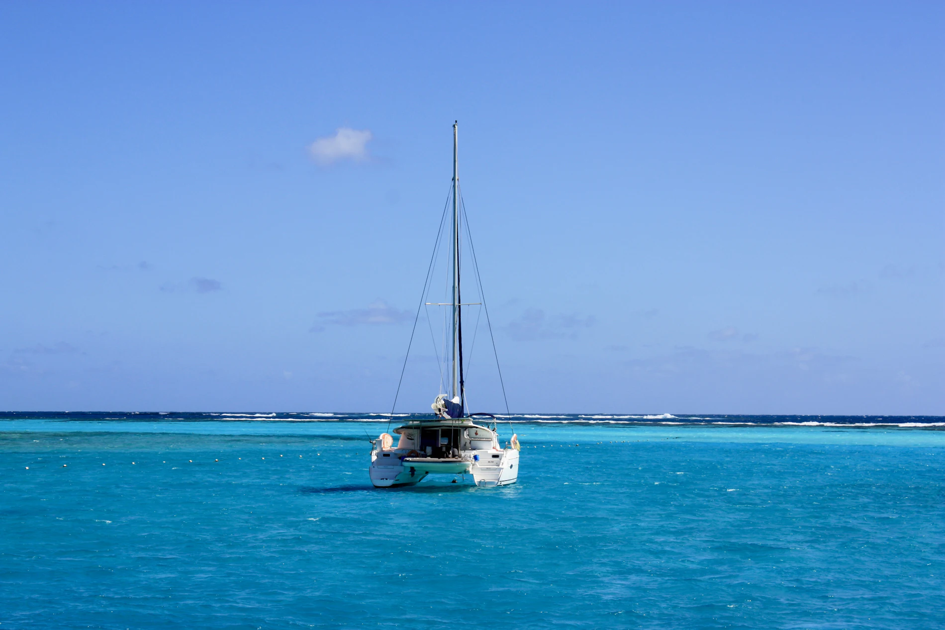White catamaran on bright turquoise water