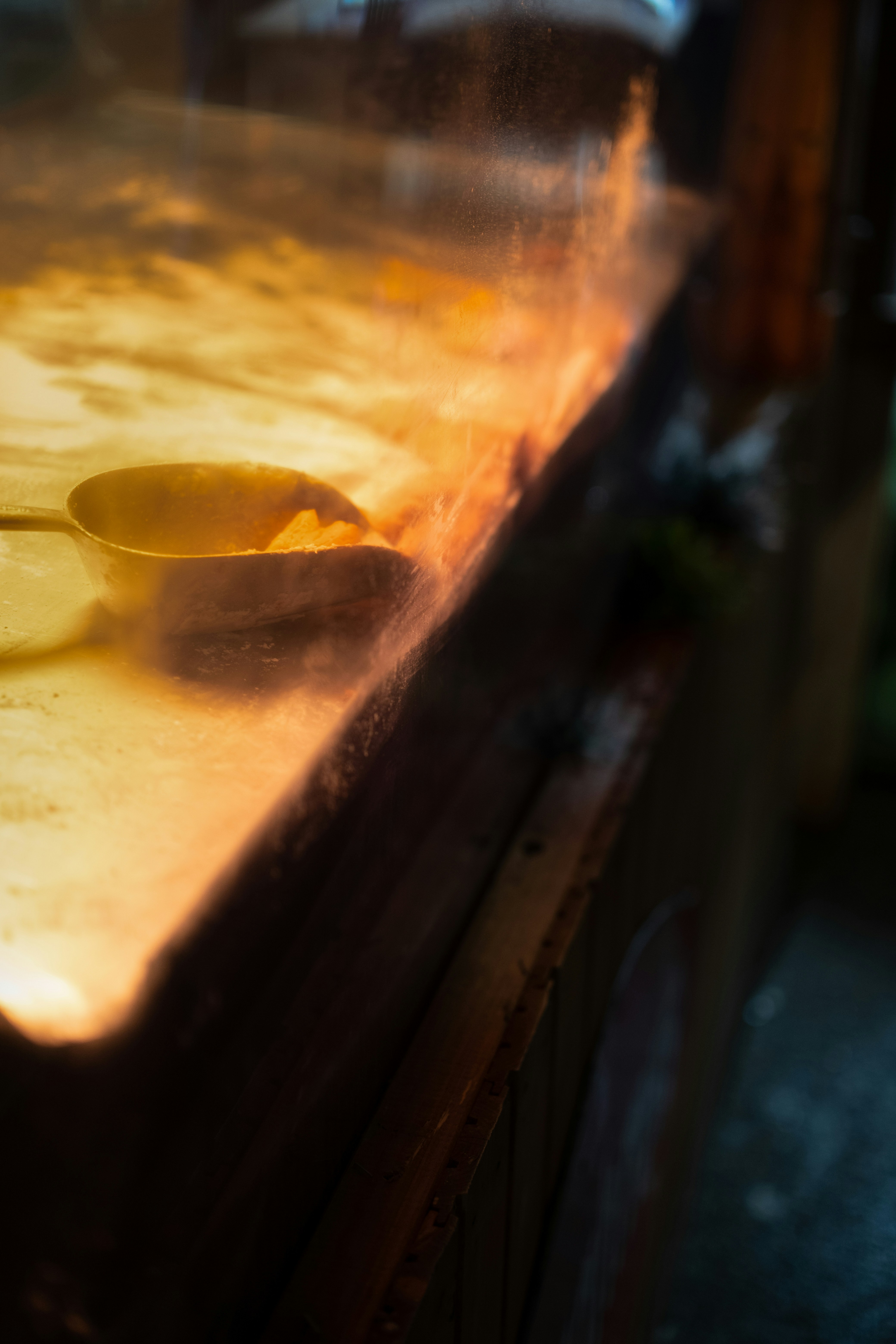 A chef cooking food on a hot griddle.