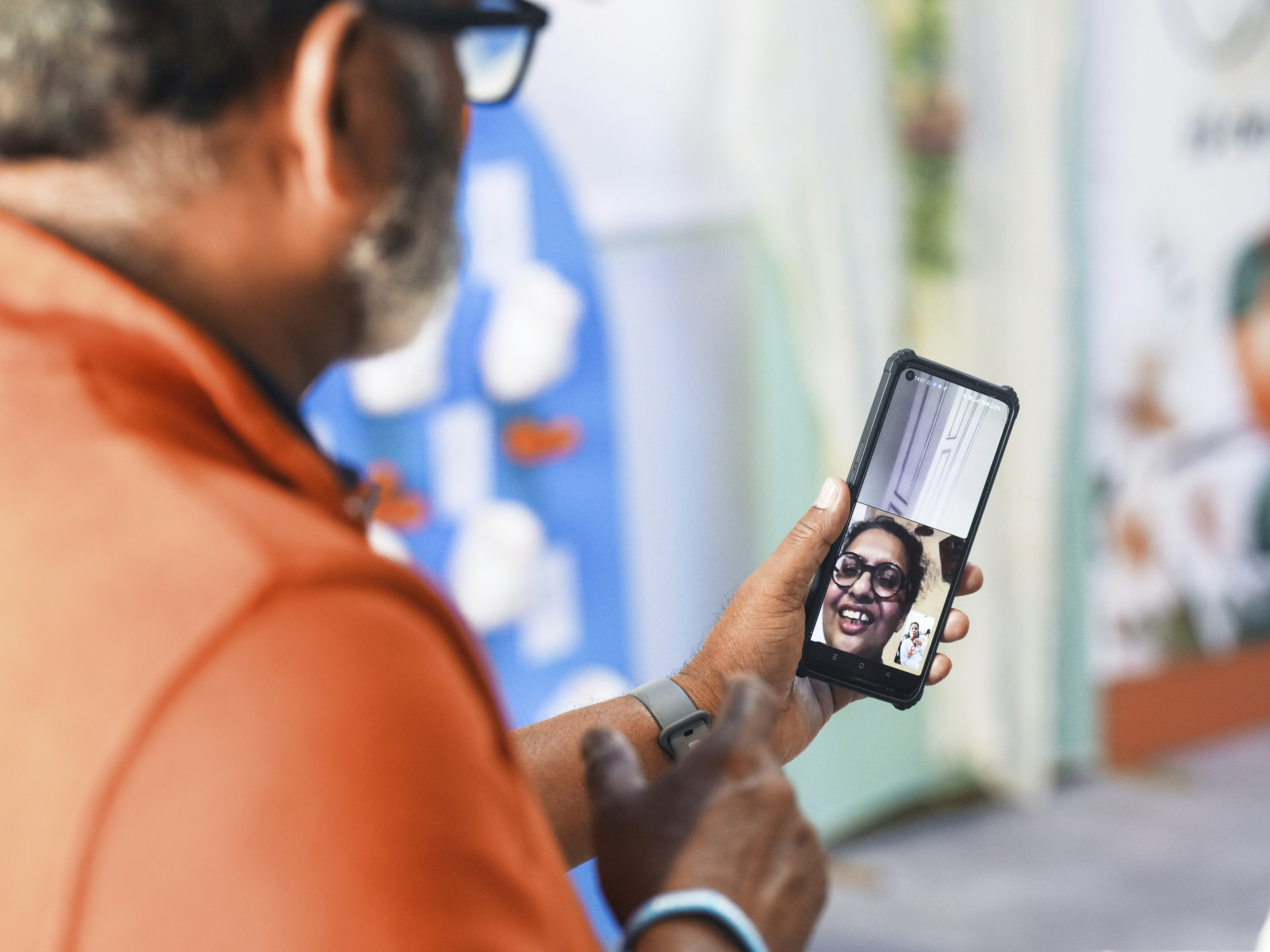 Man video calling with a smiling woman