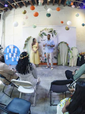 Couple standing at a wedding reception with guests
