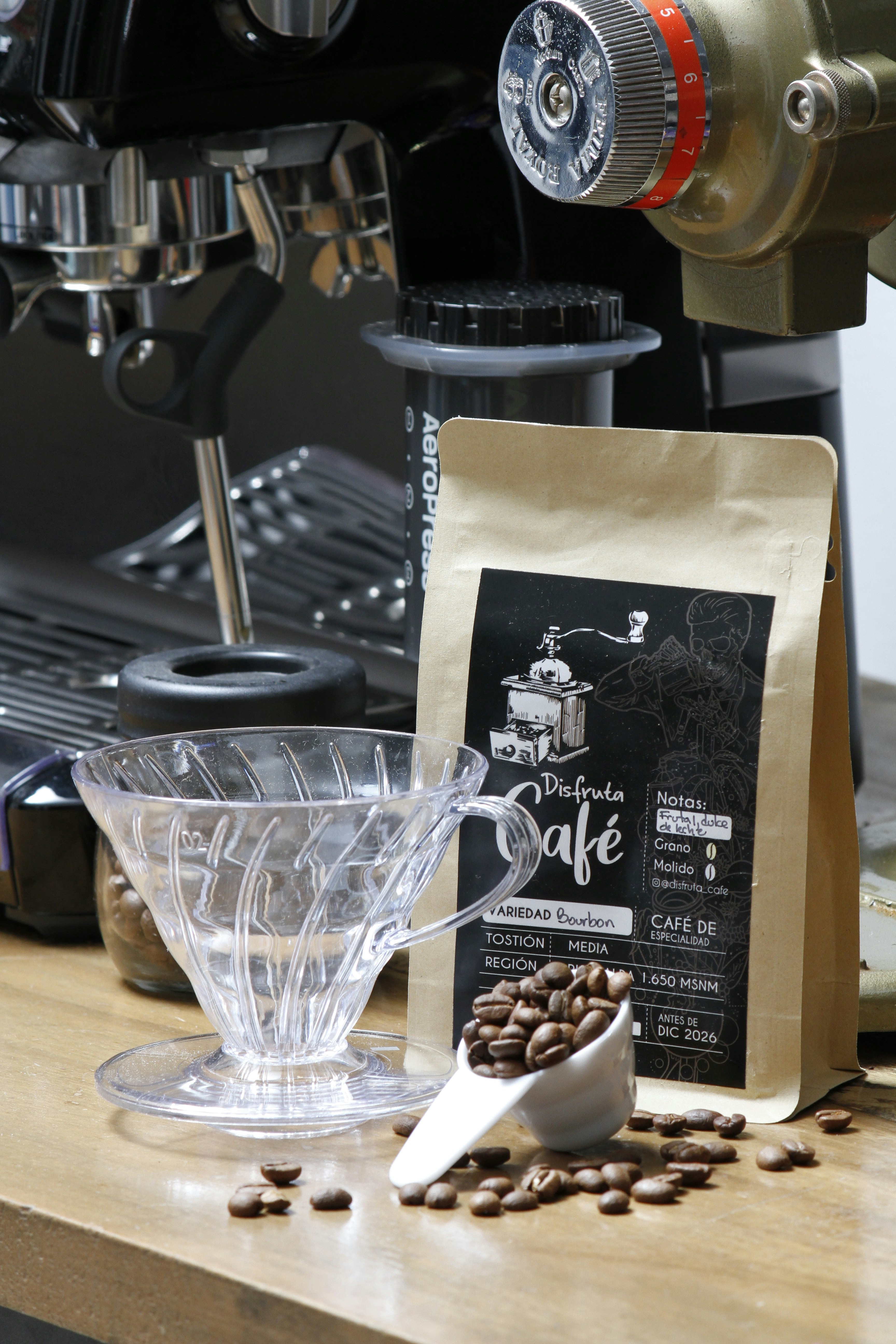 Coffee beans, filter, and bag next to espresso machine