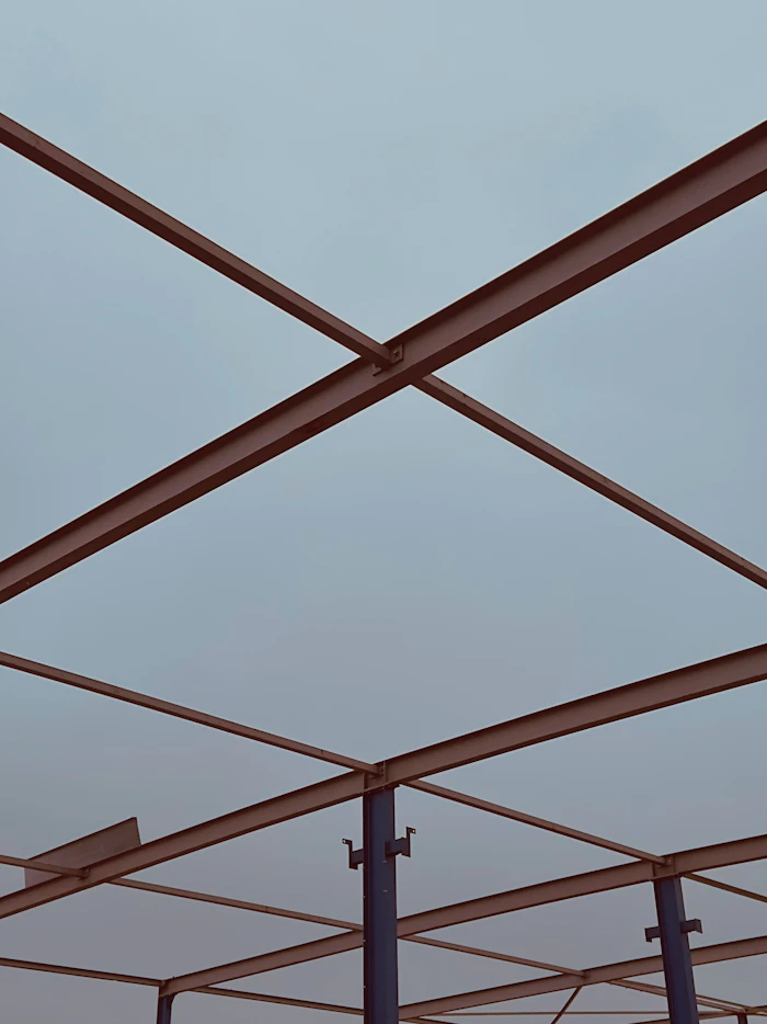Steel beams forming a geometric structure against the sky