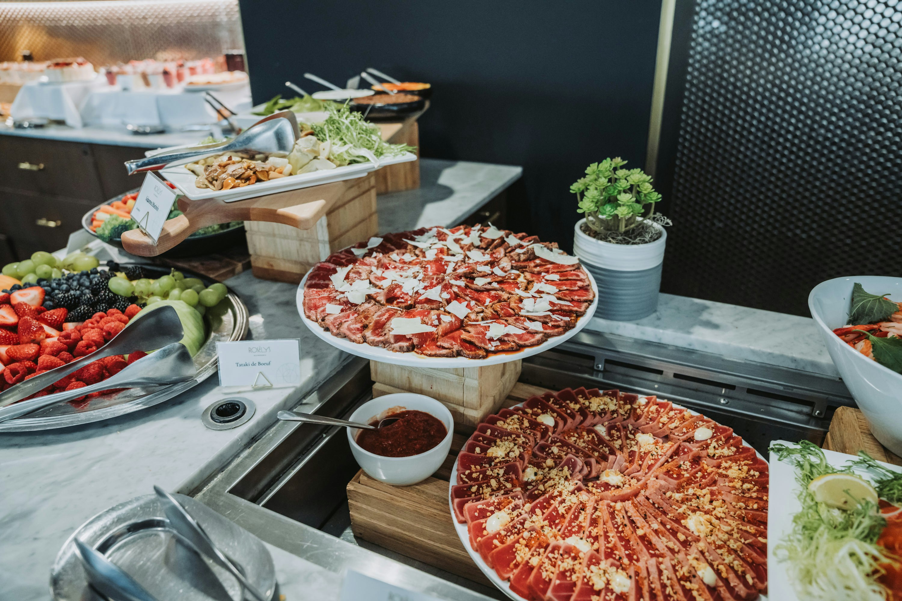 Buffet with pizzas, salads, and fresh fruit