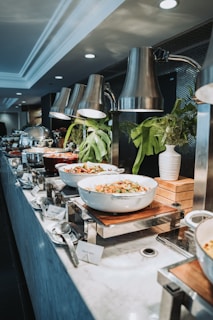 Buffet table with various dishes and plants