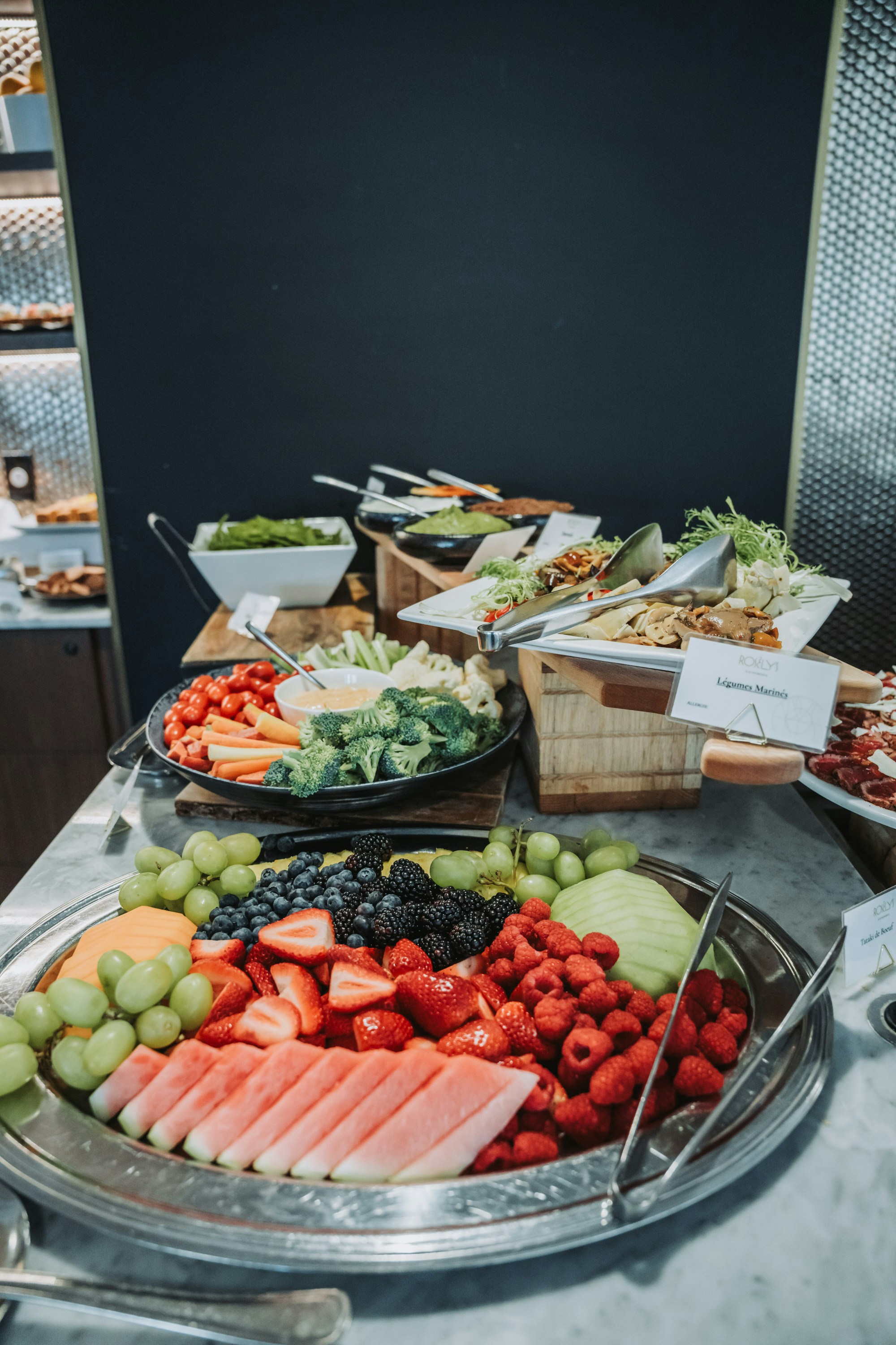 A platter of fresh fruit and vegetables with dip