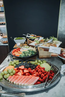 A platter of fresh fruit and vegetables with dip