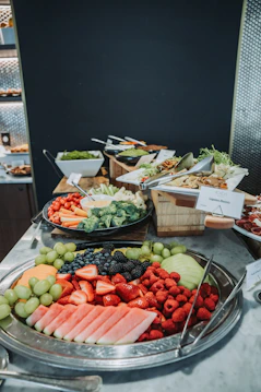 A platter of fresh fruit and vegetables with dip