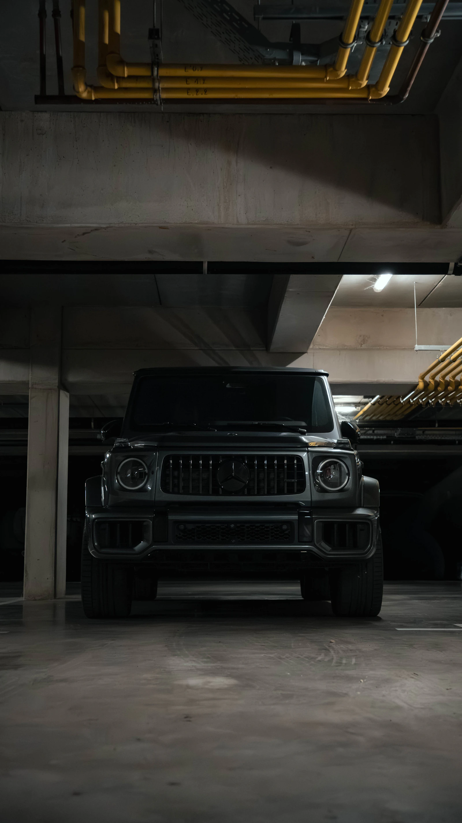 Black luxury SUV parked in the dark studio after ceramic coating
