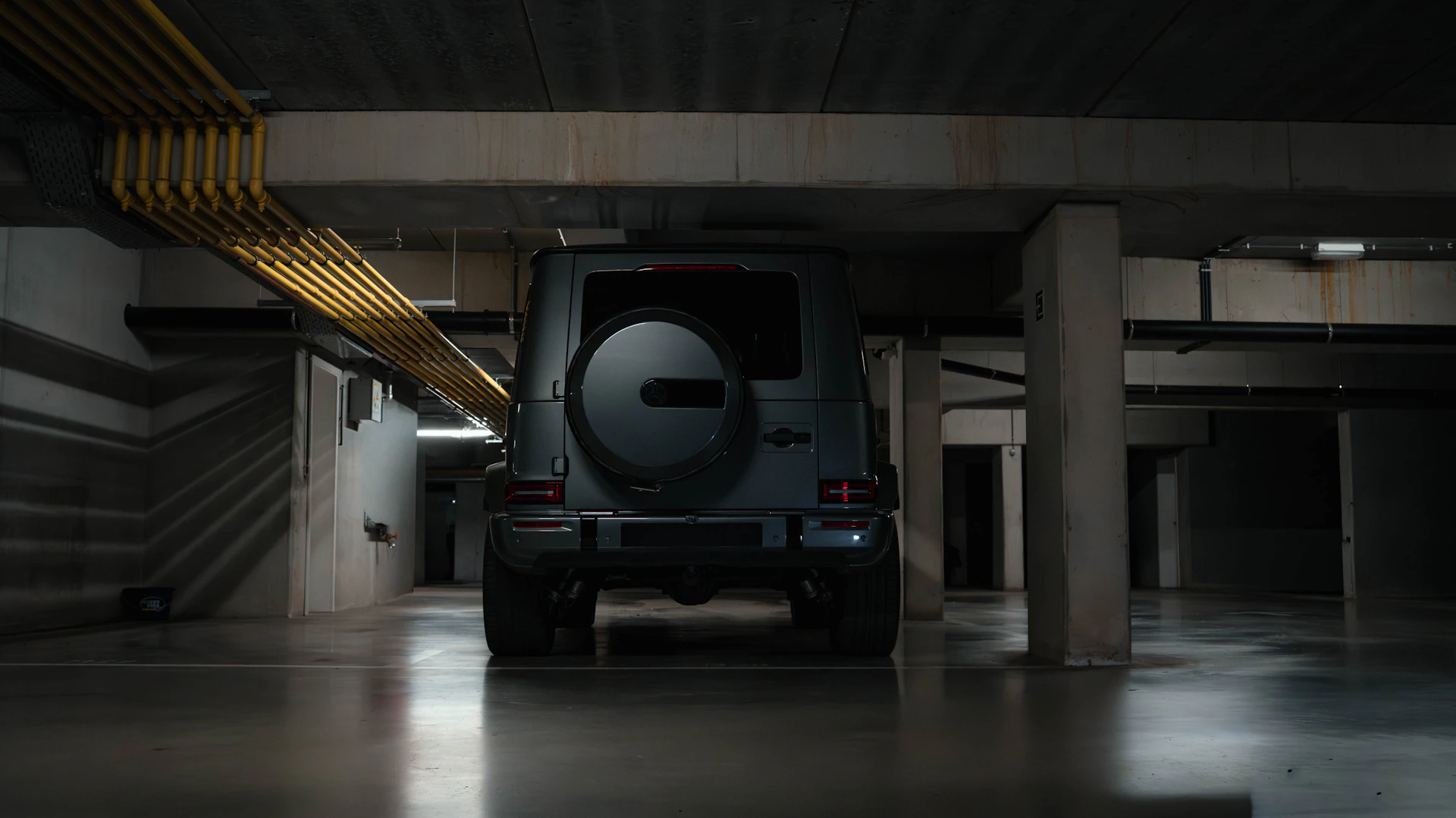 Dark suv parked in a concrete garage