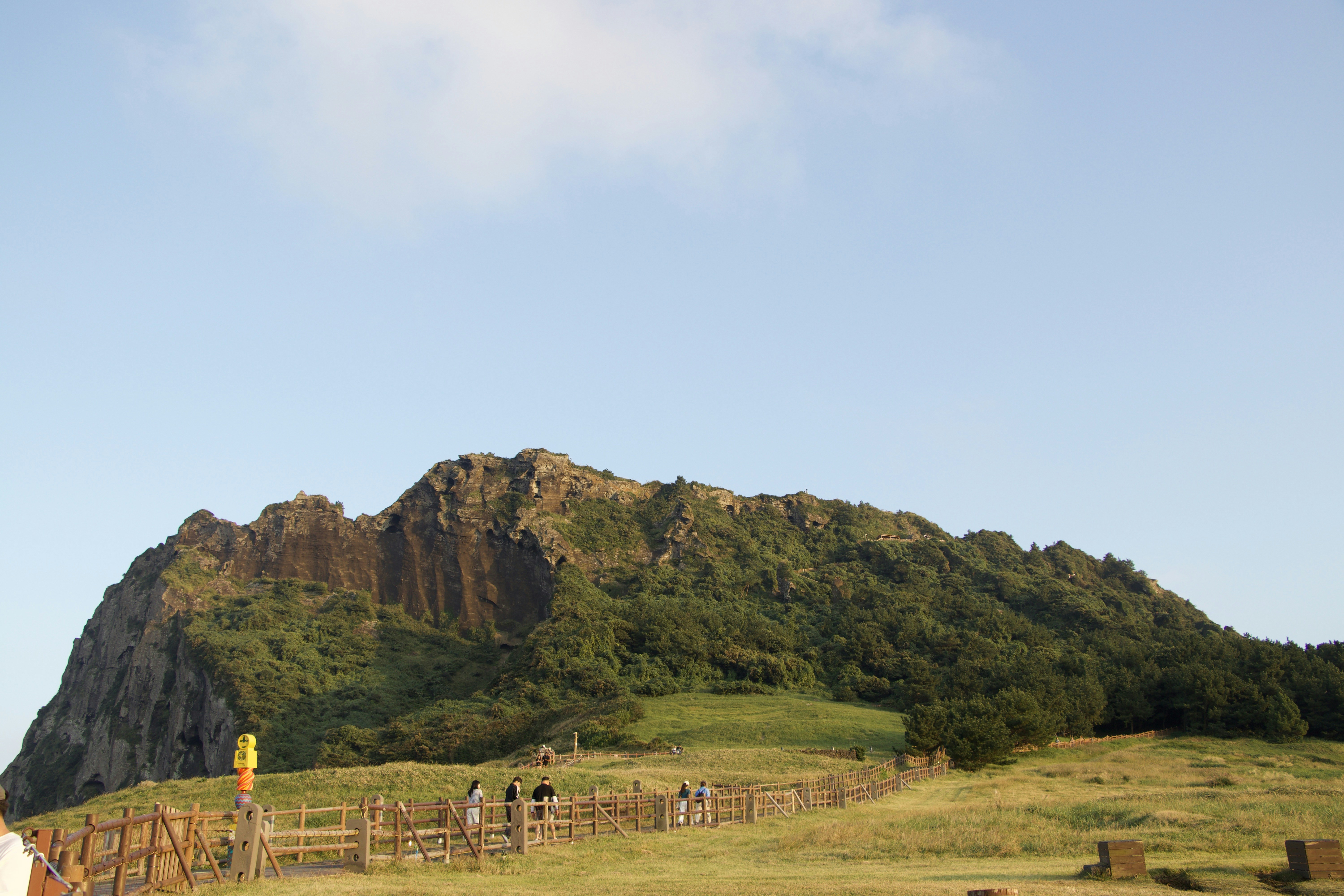Green grassy mountain under a clear blue sky