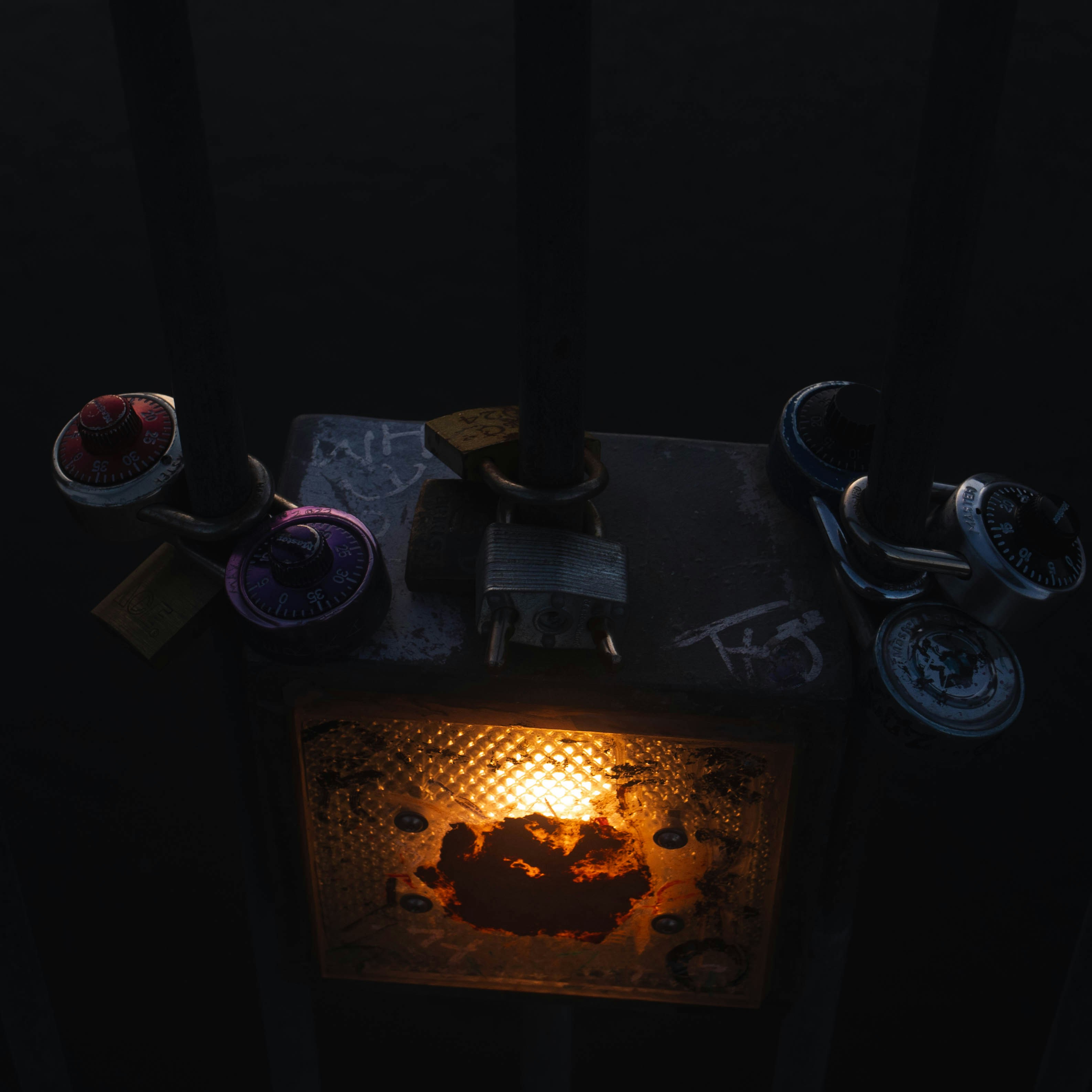 Three small toy motorcycles on a dark surface.