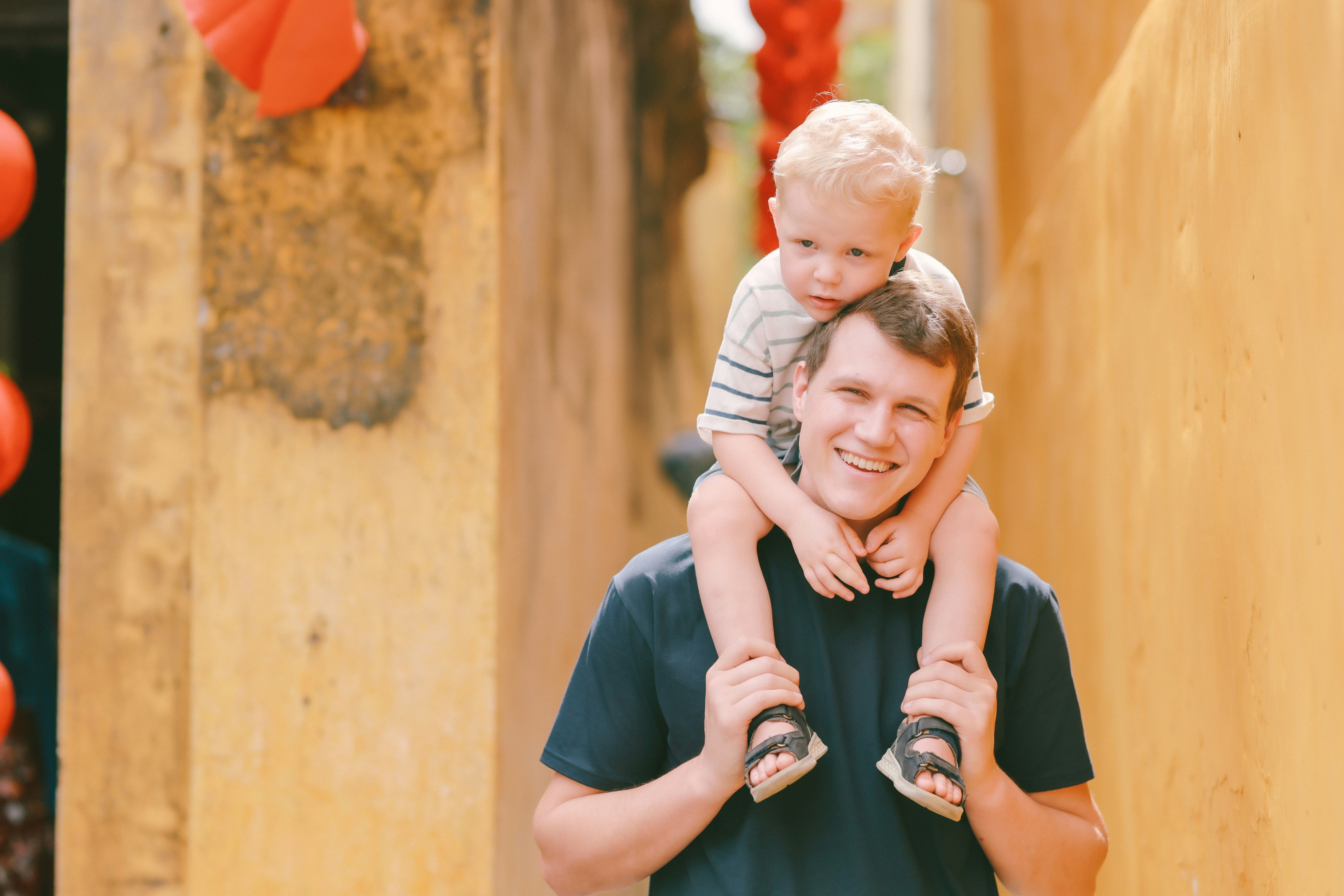 Father carrying his son on his shoulders.