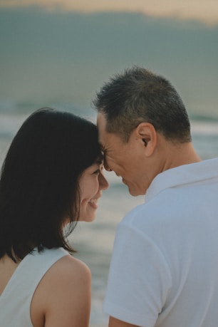 Couple touching foreheads by the ocean