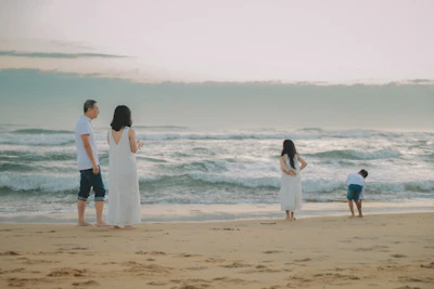 Family on beach looking at the ocean waves